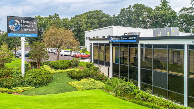 Ultimate Bimmer Services building and roadside sign.